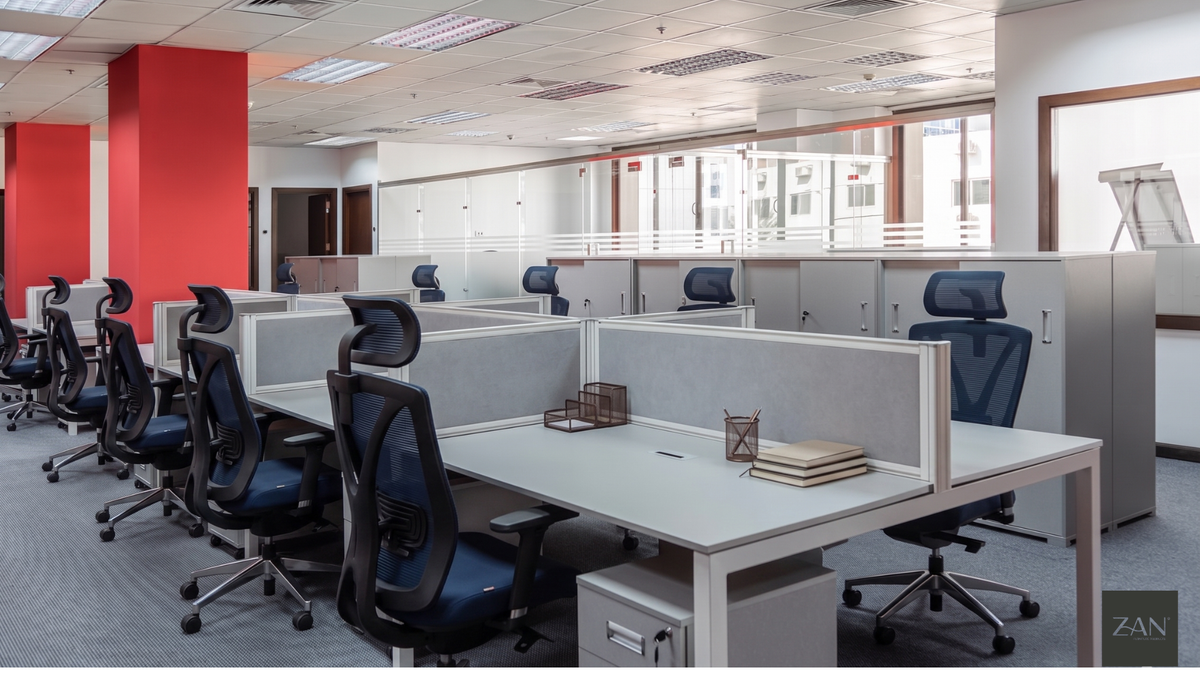 An office fitted with rows of desks, ergonomic chairs and storage pedestals